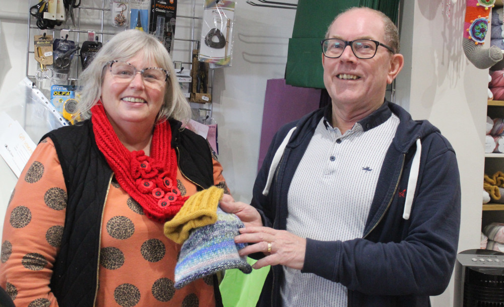 Lynda and Martin Speakman of Crafty Corner, with two of the hundreds of hats that will be donated. (Image - Alexander Greensmith / Macclesfield Nub News)