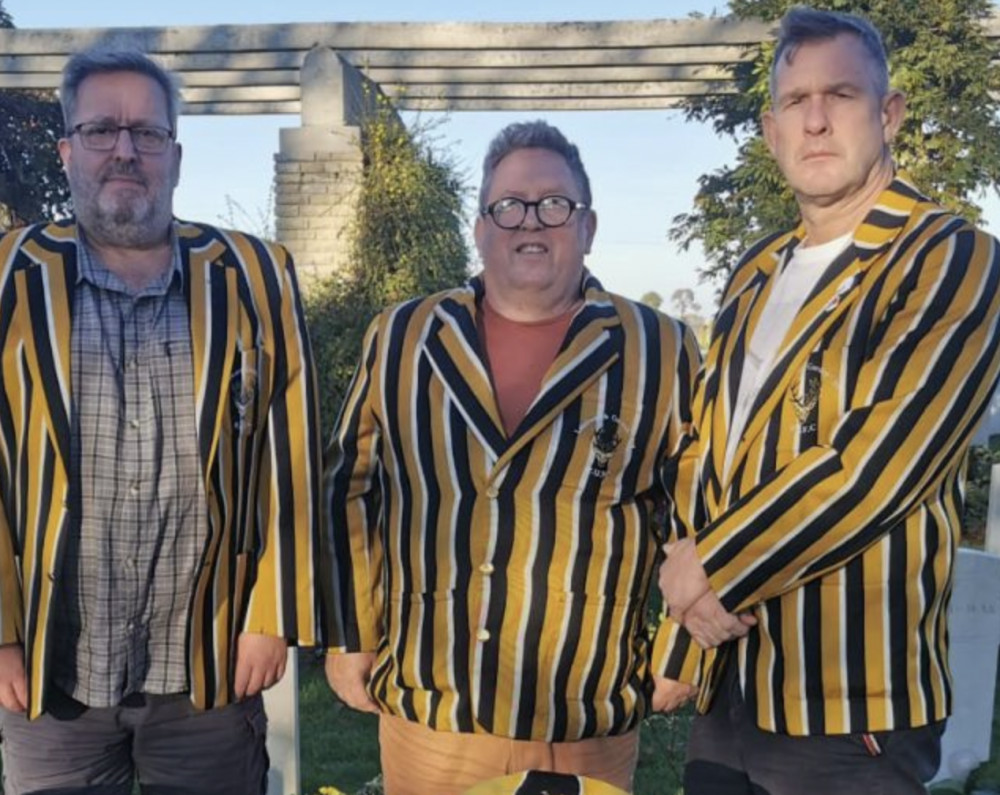 Letchworth Rugby Club's three proud Sinnatt's at the French grave of relative and World War Two fallen hero Oliver Sinnatt. CREDIT: Letchworth Rugby Club 