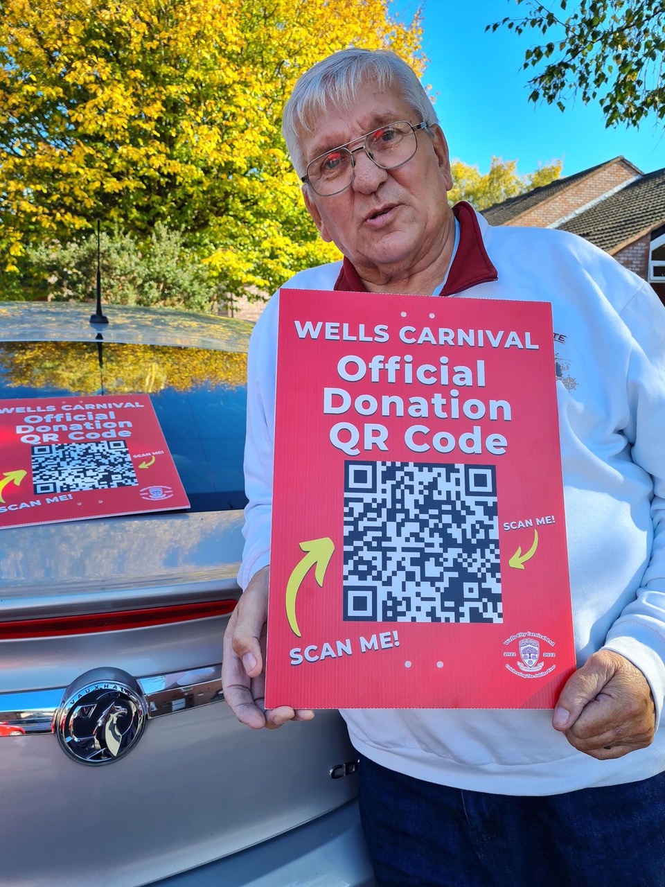 Maurice Day with one of the Wells Carnival QR posters