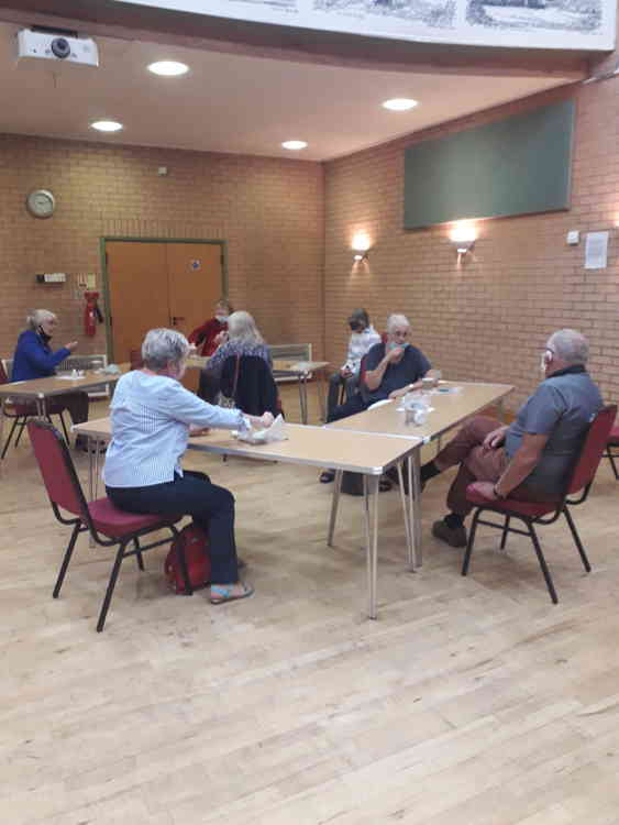 Visitors catching up over a socially-distanced coffee this week