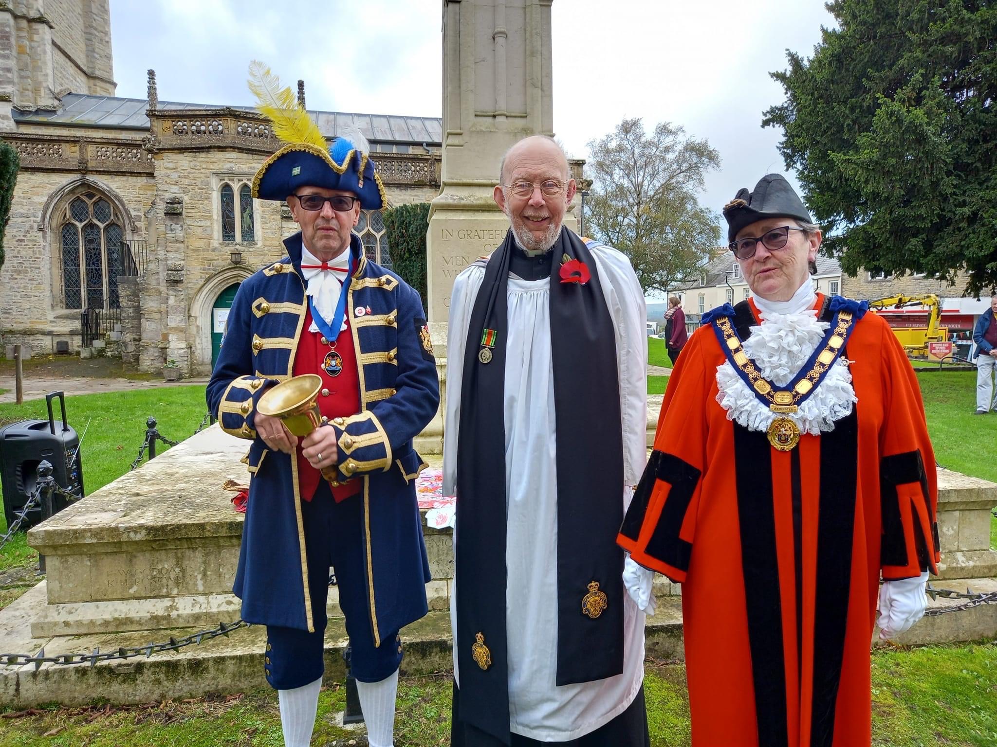 Axminster Mayor Cllr Jill Farrow pictured at the War memorial with the Reverend Clive Sedgewick and town crier Nick Goodwin