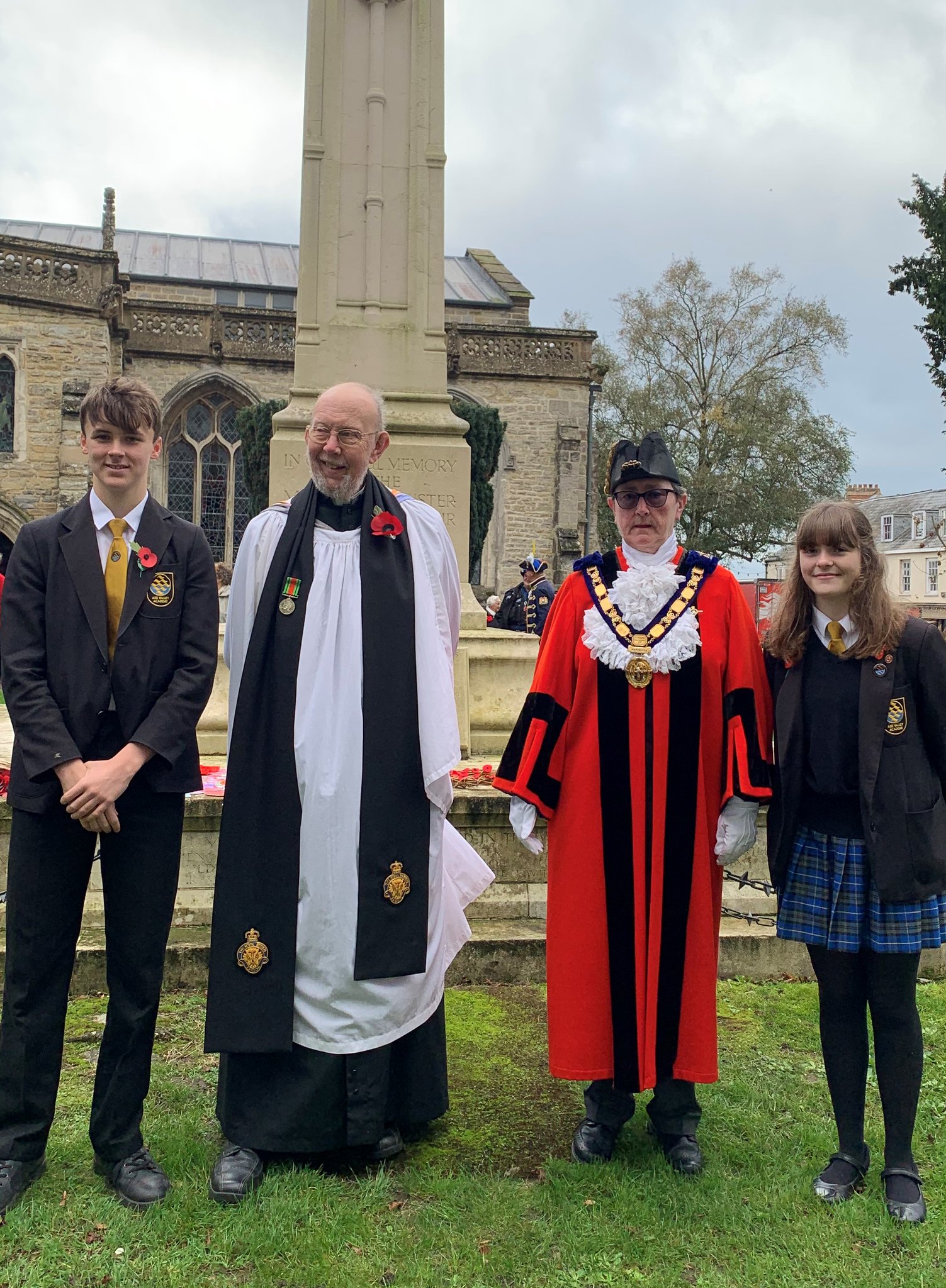 The Mayor of Axminster, Cllr Jill Farrow, pictured with the Rector, the Reverend Clive Sedgewick and the head boy and girl of Axe Valley Academy, who represented the school at the remembrance service on the Minster Green