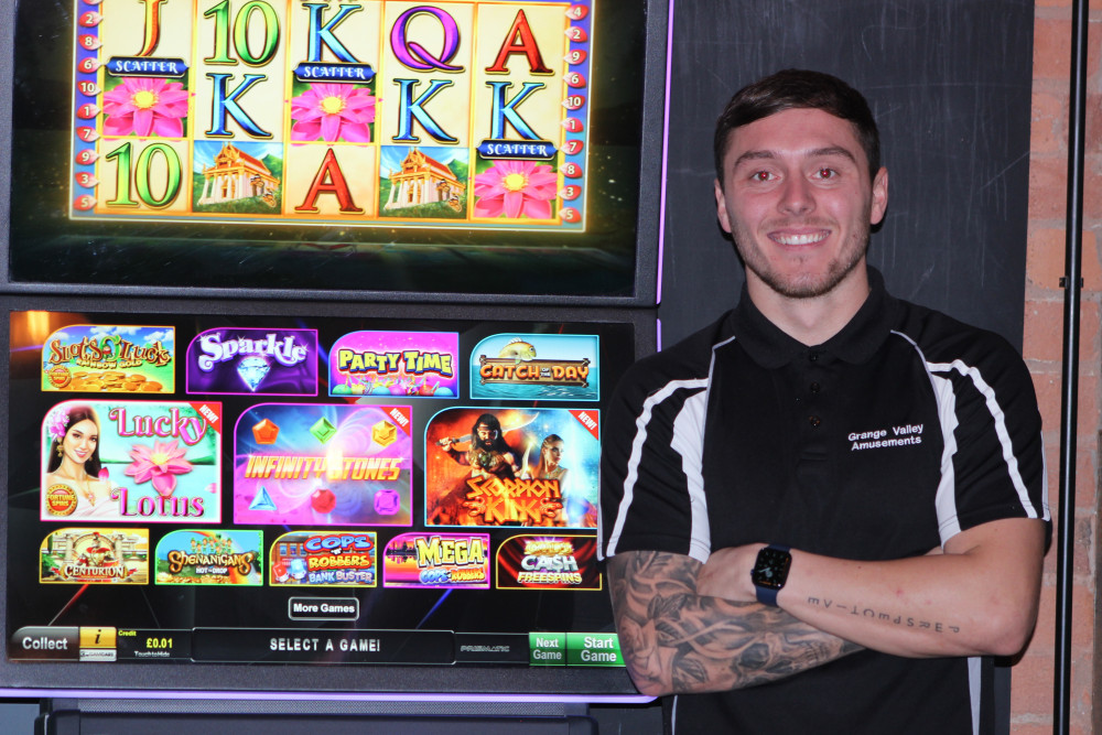 Matthew Gatley of Grange Valley Amusements with one of his machines in Macclesfield. (Image - Alexander Greensmith / Macclesfield Nub News)