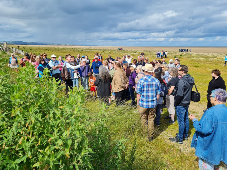 A beach tour led by Joshua Styles, an ecologist, showing residents examples of the plants growing on Hoylake Beach. Credit: Hugh Stewart.