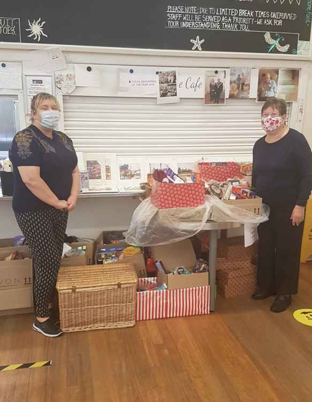 Julie Taylor, left, with a colleague and the Christmas hampers