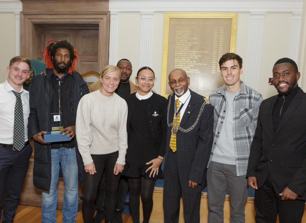 Members of FC Parkside pose with Kingston's Mayor Cllr Yogan Yoganathan and former Arsenal, Chelsea and England International, Katie Chapman. 