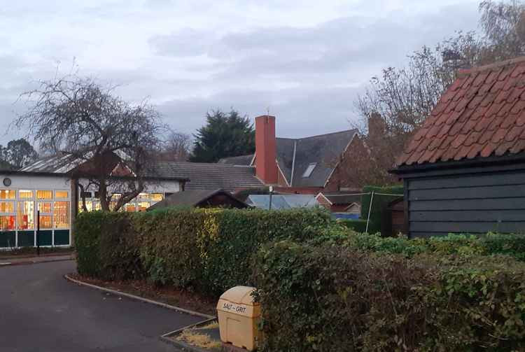 St Nicholas C of E School: leylandii are clearly visible to the rear of the building