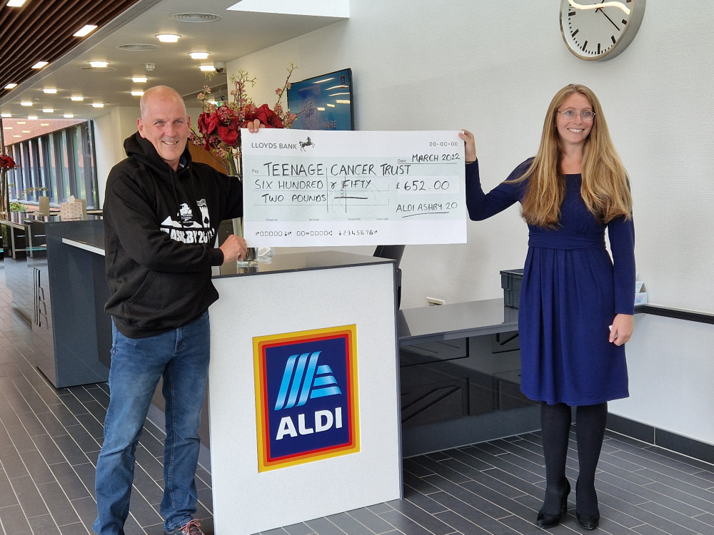 Richard Bebbington, The AA20 Race Director, presents a cheque to Liz Fox, Aldi Corporate Responsibility Director