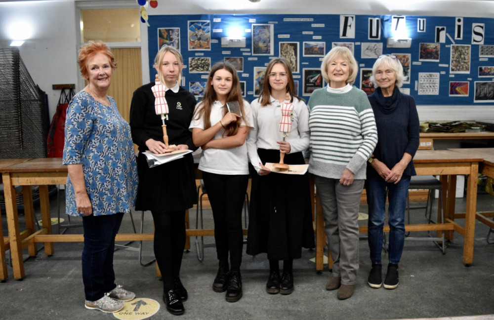 Penryn College students proudly display their awards alongside Arts Society Falmouth representatives.