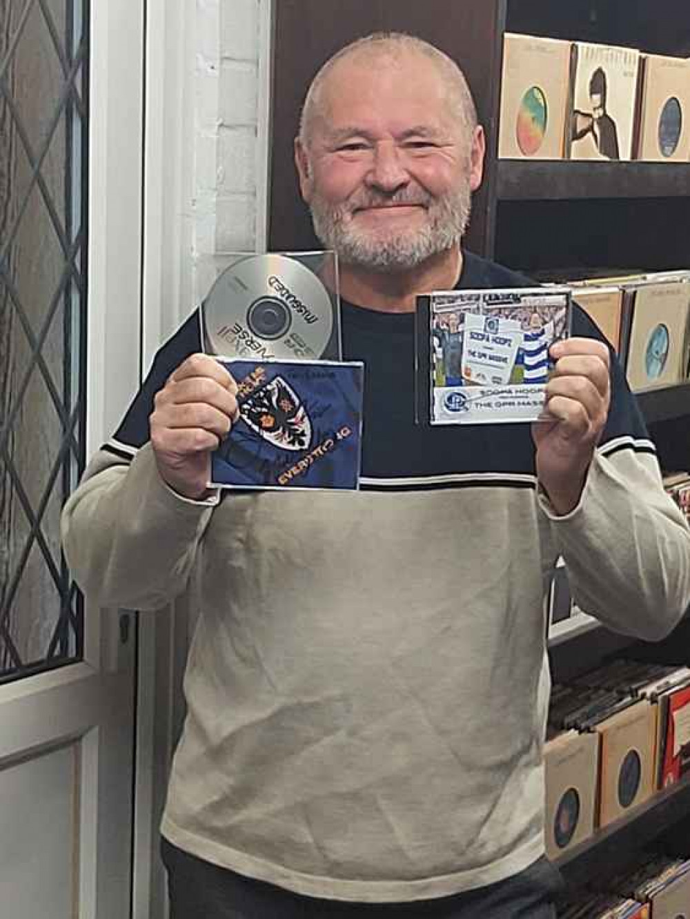Kevin Briggs in his purpose-built record library, with the three elusive singles which now completes his collection of every Top 75 single since November 1952