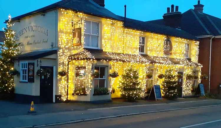 All lit up for Christmas: the pub is an iconic festive sight