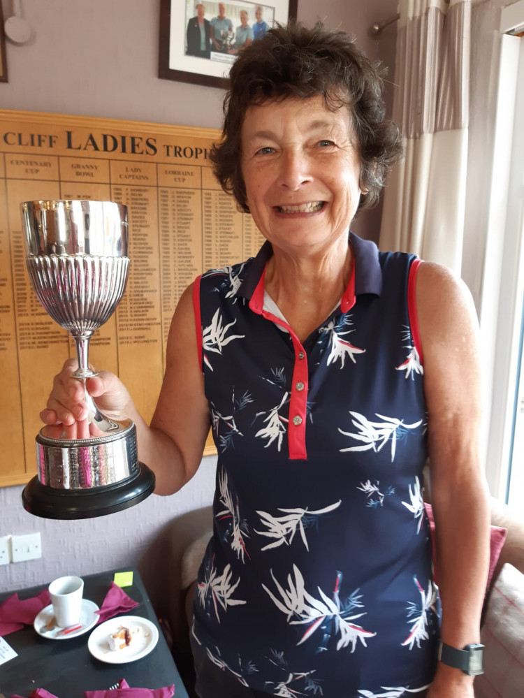 Stella Thompson, the new Ladies captain at Axe Cliff,  is pictured holding up one of her trophies.