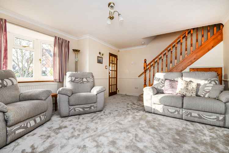 The spacious lounge area with stairs to the first floor