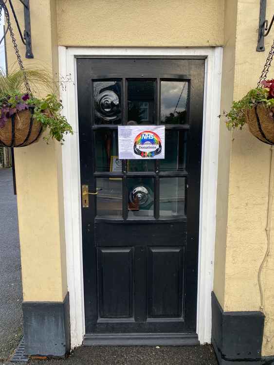 The side door at The Queen Victoria pub in Maldon: the tray for donations is behind it