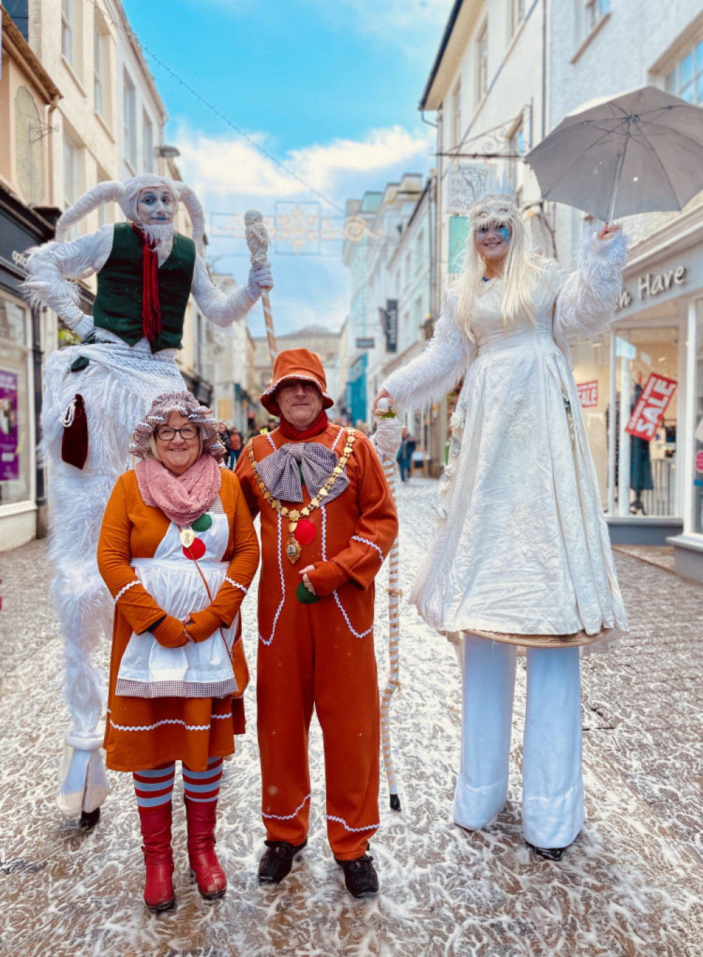Cllr Steve Eva, Mayor of Falmouth and Mayoress Victoria with Christmas stilt walkers. (Image: Richard Wilcox/Falmouth BID)