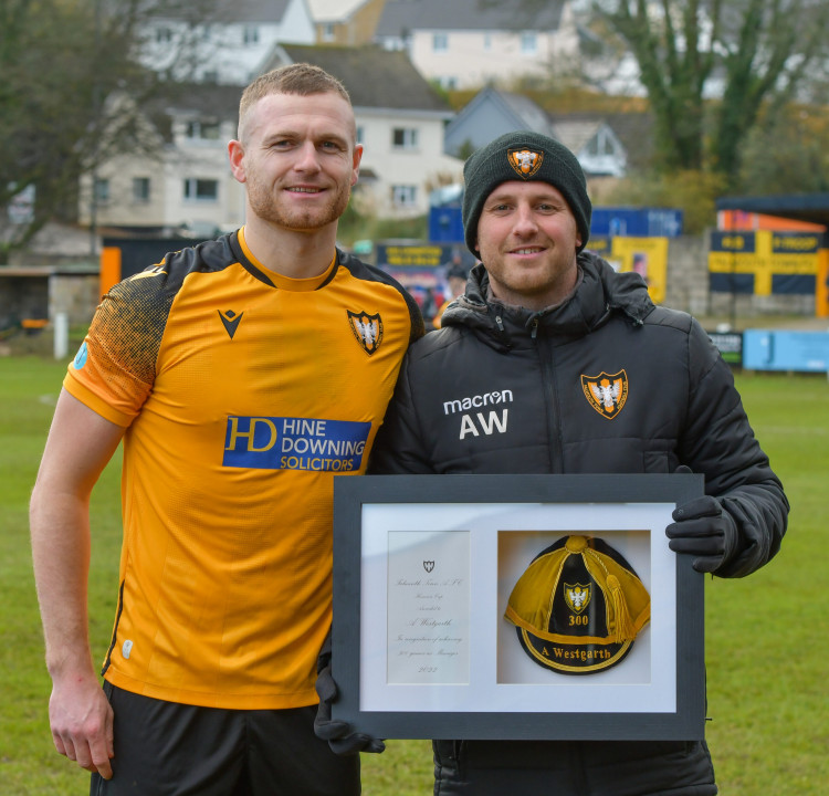 Town skipper James Ward (left) presents Westgarth with a commemorative cap prior to Saturday’s 5-4 win over Barnstaple Town. (Image: Falmouth Town/ Cornwall Sports Media) 