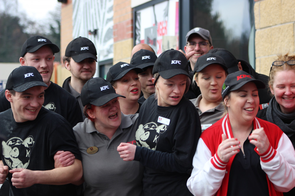 Staff react to the ribbon being cut at Macclesfield's new KFC restaurant. (Image - Emma Trimble)