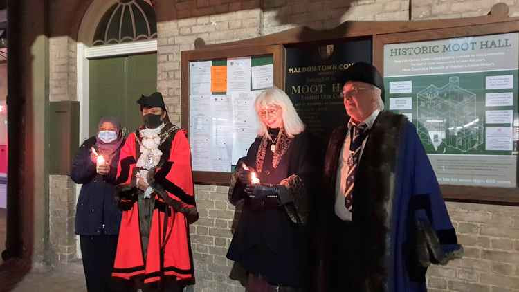 The four gathered with candles to remember those lost in the past year