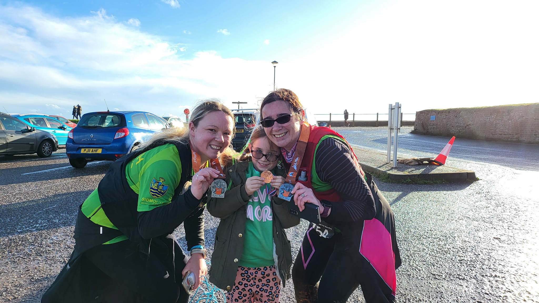 Donna and Amelia Womersley-Westlake proudly display their medals with Clare Luke