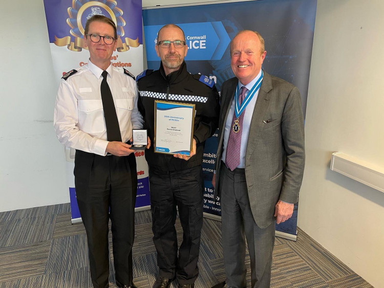 Darren (centre) receiving his award (Credit: Devon and Cornwall Police)