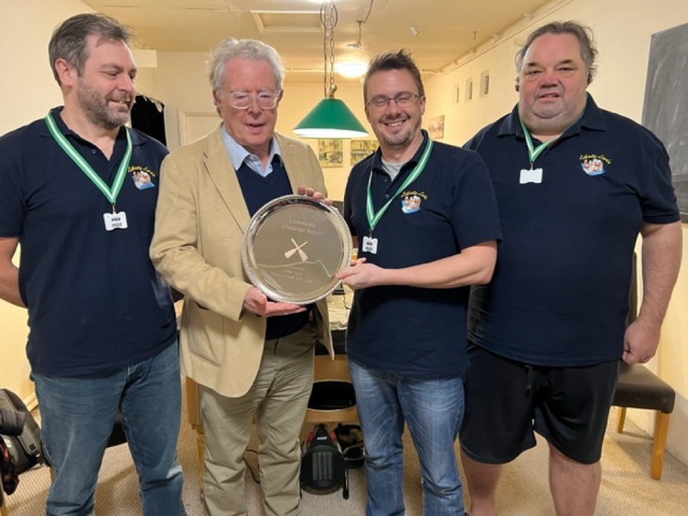 Philip Welch presents three of the Likely Lads with the Community Challenge Salver