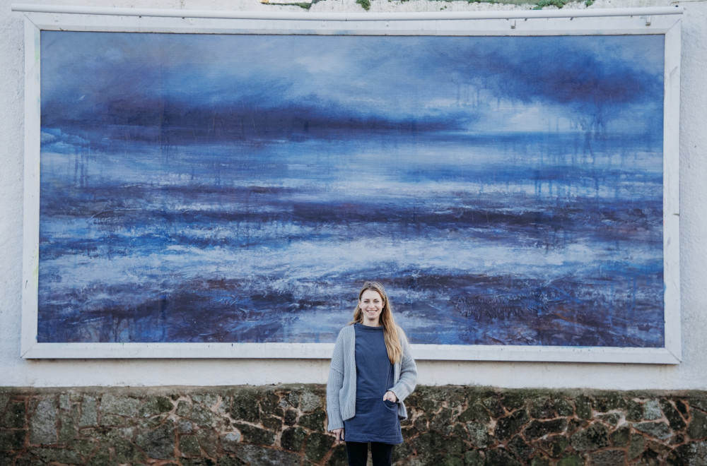 Jennifer Bennett in front of the billboard artwork ‘Reminding Myself’ at Sidmouth Wallspace (Sarah Hall)