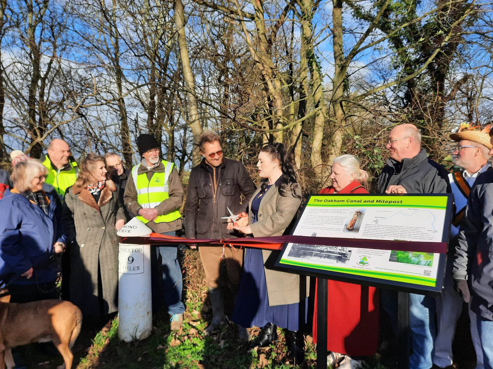 Alicia Kearns pictured with volunteers and members of the public cutting the ribbon.