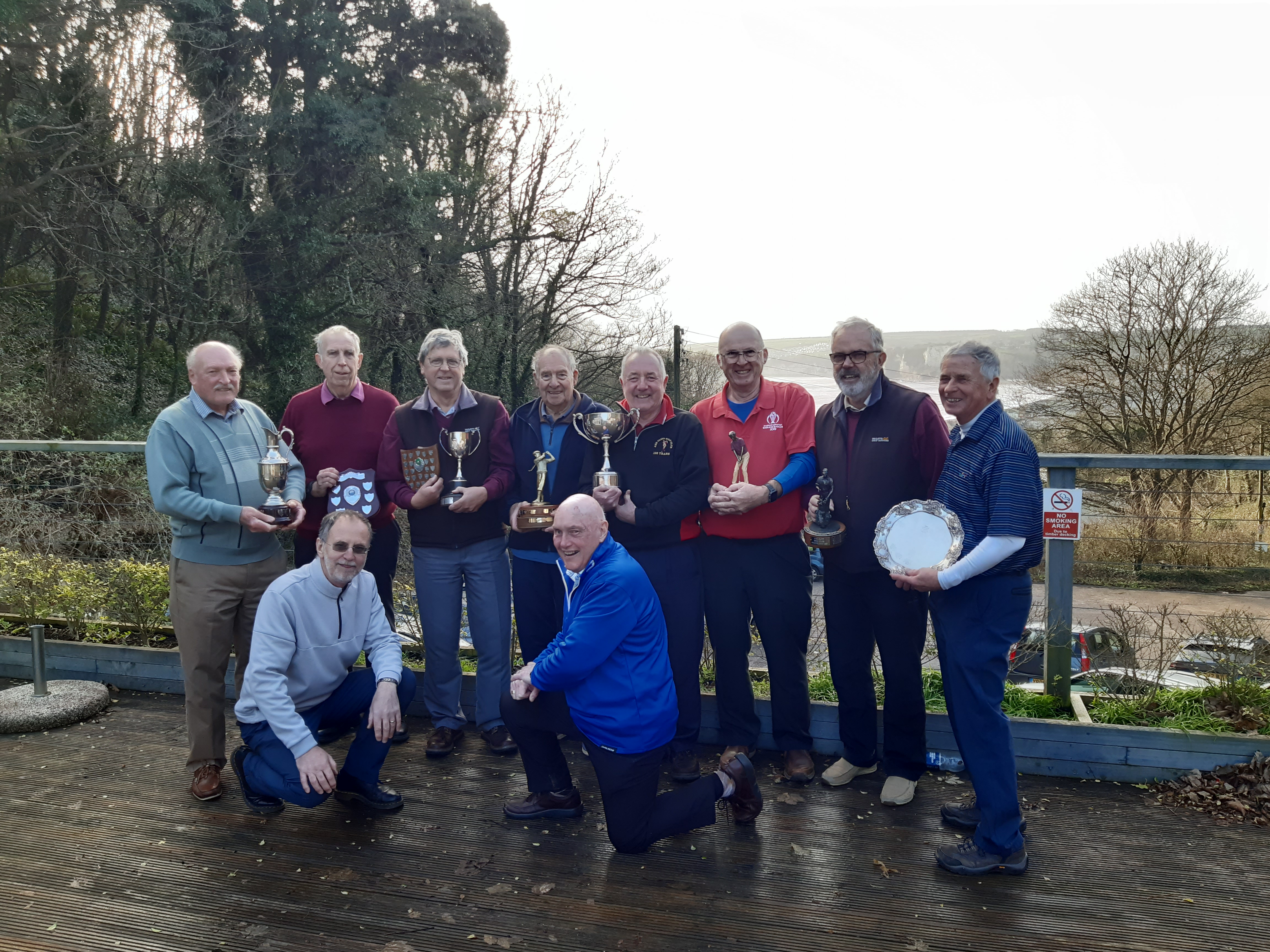 Steve Thompson and Dave Lacey on their knees with a good number  of winners overlooking Seaton Bay outside the clubhouse.