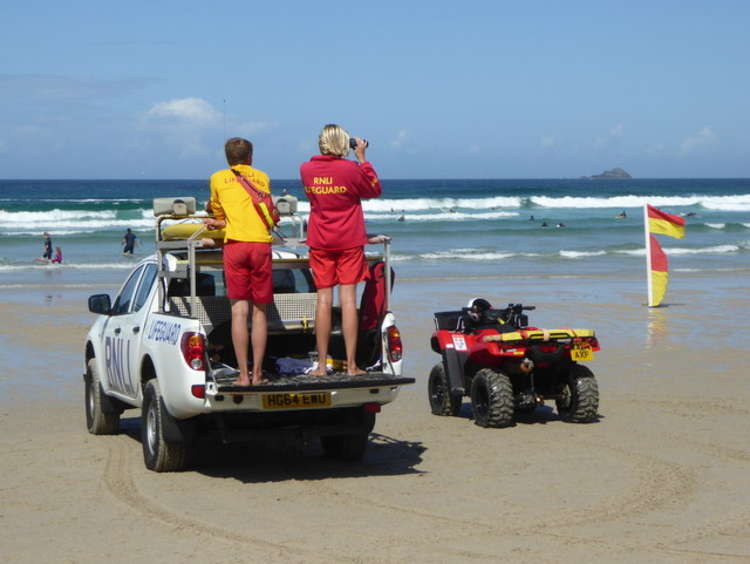 RNLI lifeguards on duty on Sennen beach (cc-by-sa/2.0 - © Rod Allday - geograph.org.uk/p/4641879)