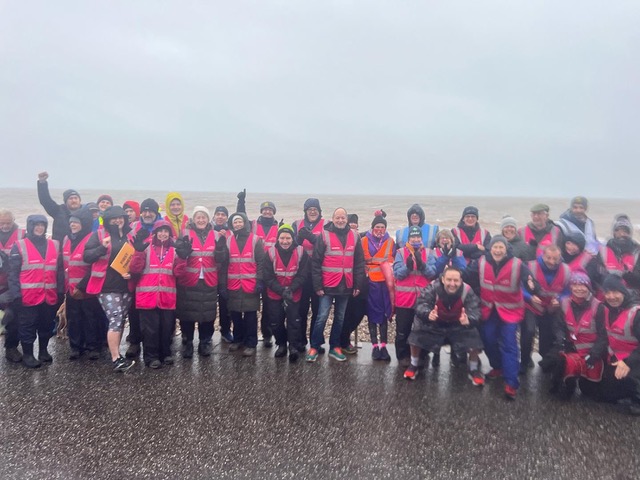 Volunteer marshals celebrating the 250th Seaton park run in the rain