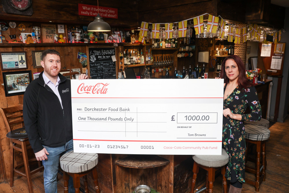 Tom Browns in Dorchester has donated £1,000 from Coca-Cola to the Dorchester Food Bank
