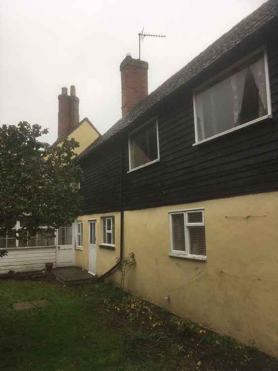 A rear view of the house showing some of the windows earmarked for replacement with more historically appropriate frames