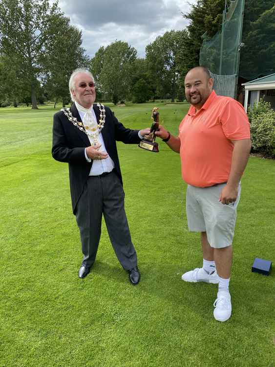 Winner James is presented with the Dave Carr Trophy