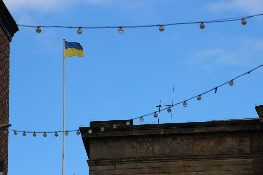 A Ukrainian flag flies above Macclesfield Town Hall, shot from Church Street. (Image - Alexander Greensmith / Macclesfield Nub News) 