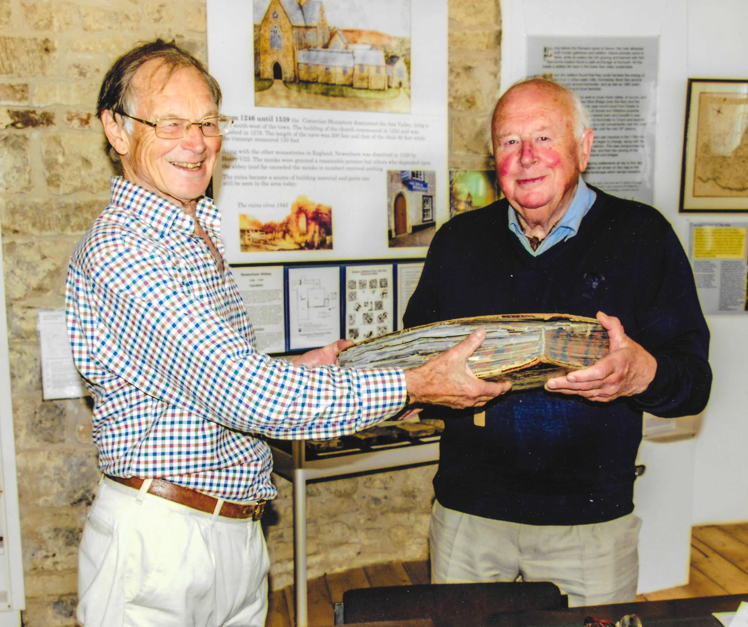 Dr John Church accepting the donation of George Pulman's own bound manuscript copy of 'The Book of the Axe', written 1871-75