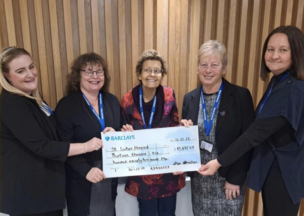 Sandra and volunteers present the cheque to St Luke's Hospice. 