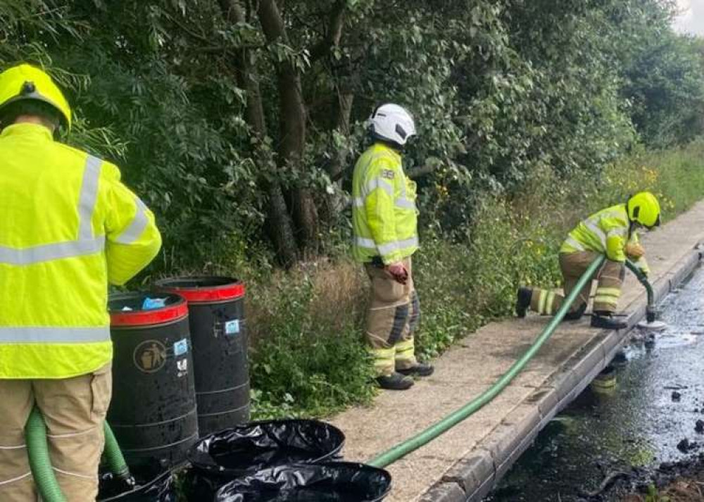 Firefighters clearing the leaked liquid at the site this afternoon