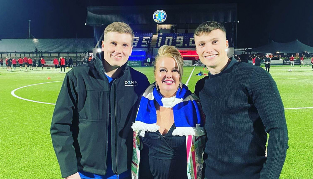 Shaun Conway, Customer Relationship Manager at D2NA, Cheryl Chadwick, D2NA’s Marketing Director, and Max Bardsley-Rowe, Commercial and Sponsorship Manager, Macclesfield FC, on the pitch at The Leasing.com Stadium. (Image - Nigel Howle)