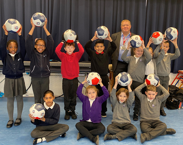 Commercial director Peter Ward with the winning youngsters.