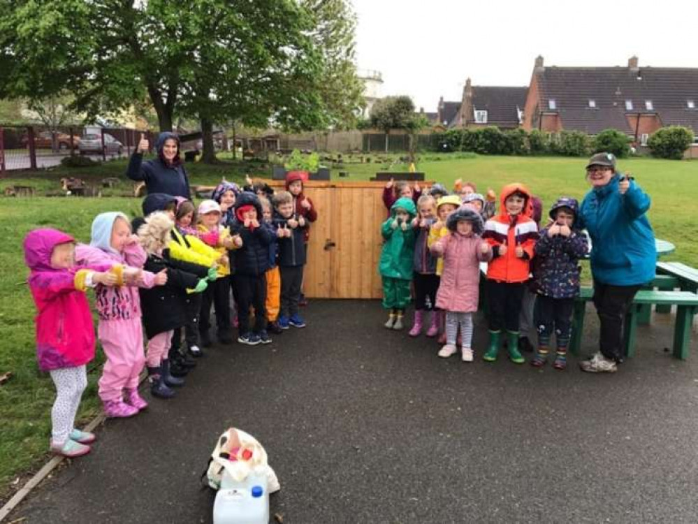 Pupils at All Saints Primary School with the new storage shed funded by Taylor Wimpey