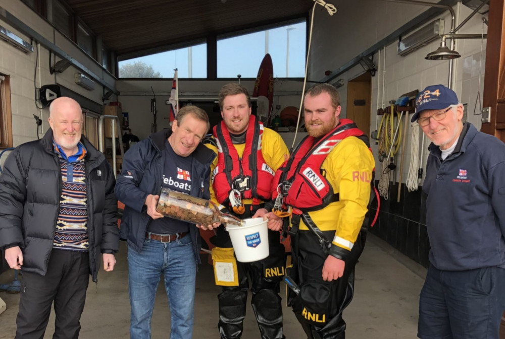 Volunteers decant the whisky bottle. L to R: Rob Anderson, Des White, James Edge, Henry Mock, Dave Atkinson (Exmouth RNLI)
