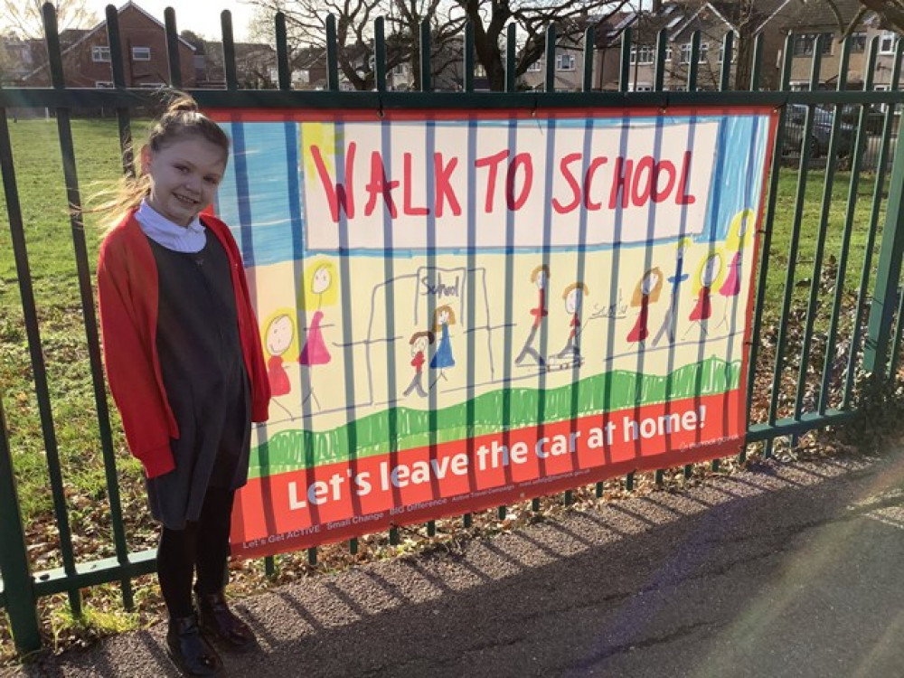 Elsie-Rose Lloyd with her winning banner on display outside Horndon on the Hill Primary.