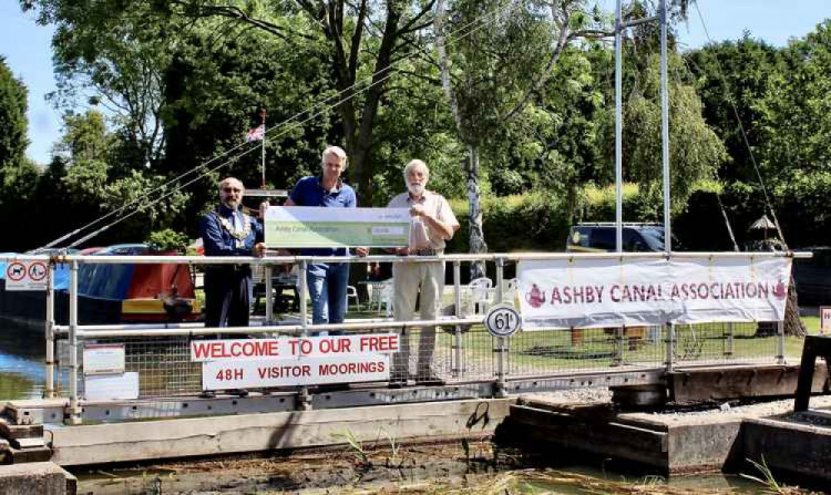 Former North West Leicestershire District Council chairman Virge Richichi and council leader Richard Blunt presented a cheque to Peter Oakden, Chairman at Ashby Canal Association, in 2021