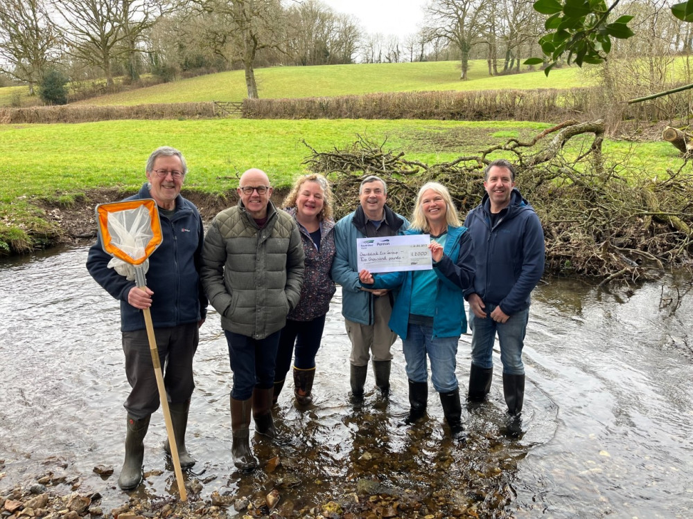 Members of the Kit Brook Restoration Project collect a cheque from South West Water