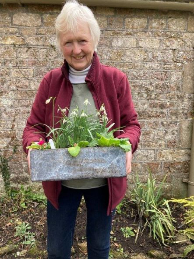 Member Frances Horler won the first prize in the raffle, a planted trough of coloured primroses 