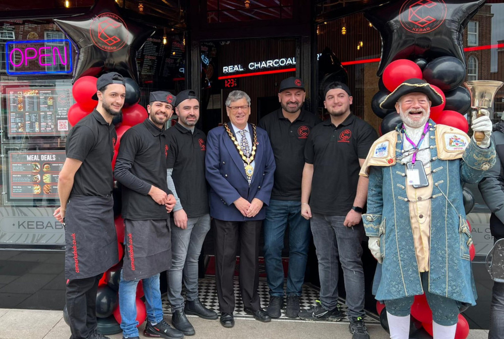 Mayor of Exmouth Cllr Steve Gazzard, centre, and Town Crier Roger Bourgein, right, with Corner Kebab staff (Corner Kebab)