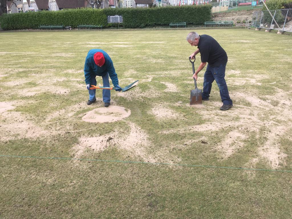 Spreading the top dressing on the green