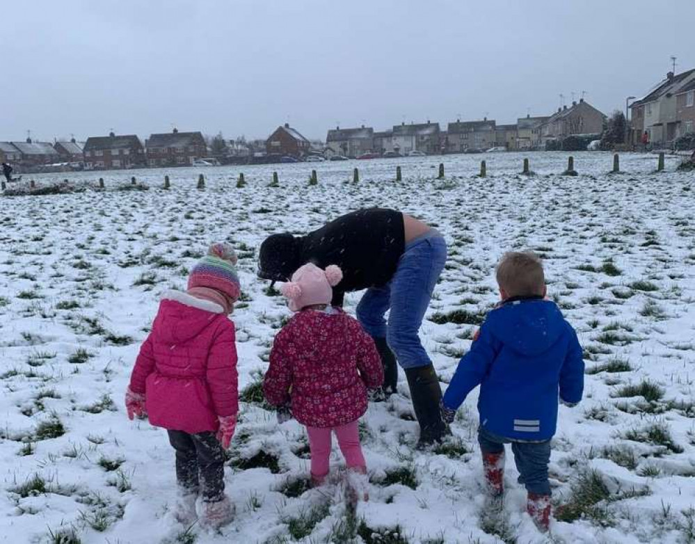 Children and parents enjoying a snow day on Primrose Meadow, on Mundon Road