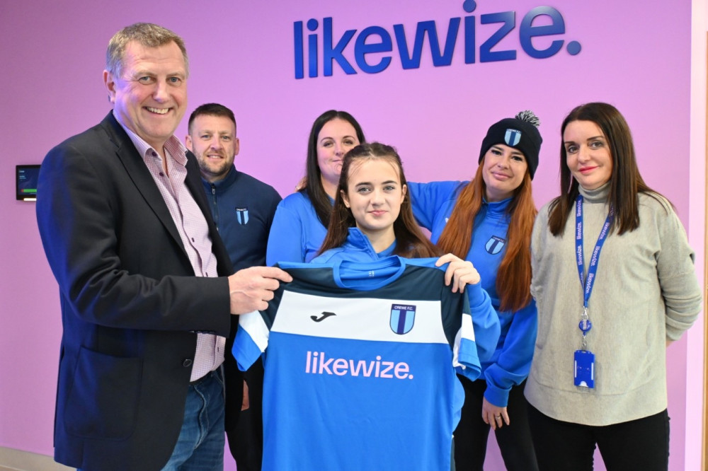 Crewe FC’s Evie Skelton presents new shirt to Likewize Executive Vice President Gerry O’Keeffe and People Director Lisa Crawford (Image - Likewize)