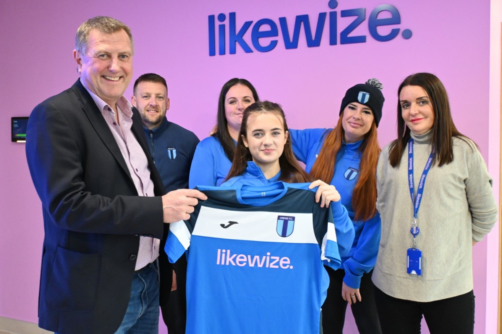 Crewe FC’s Evie Skelton presents new shirt to Likewize Executive Vice President Gerry O’Keeffe and People Director Lisa Crawford (Image - Likewize) Crewe FC’s Evie Skelton presents new shirt to Likewize Executive Vice President Gerry O’Keeffe and People Director Lisa Crawford (Image - Likewize)